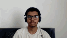 a young man wearing glasses and headphones has a sticker on his shirt that says nike
