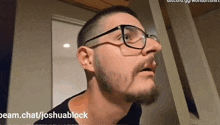 a man with a beard and glasses is making a face .