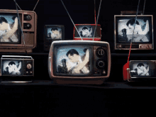 a bunch of old televisions are lined up on a black background