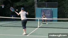 a man and a woman are playing tennis on a court with a banner that says court
