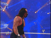 a man in a black tank top with a w on the back
