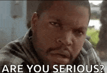 ice cube is making a serious face while sitting at a table and says `` are you serious ? ''