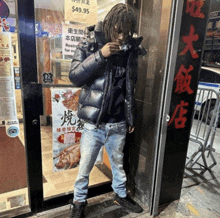 a man standing in front of a restaurant with a sign that says $ 49.99