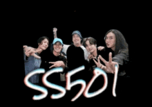 a group of people standing next to each other with the letters ss501 visible