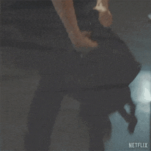 a person is carrying a backpack in a dark room while walking .