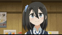 a girl with a blue bow in her hair is smiling in front of a sign that says ' a '