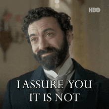 a man with a beard is smiling and says i assure you it is not