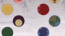 a bunch of circles of different colors are floating in the air