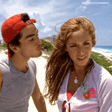 a man in a red hat kisses a woman on the cheek with the caption colucciyarango