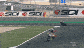 a person riding a motorcycle on a race track with a sign that says sdi