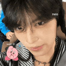 a close up of a person 's face with a sticker of kirby and the word neo