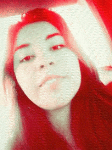 a girl with red hair is taking a selfie
