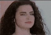 a close up of a woman 's face with a serious look on her face