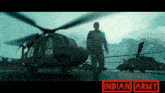 a man is walking in front of a helicopter with the number h114 on it