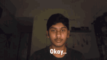 a young man giving a thumbs up with the words okay written below him