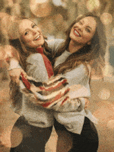 two women are hugging each other and smiling for a picture