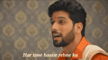 a man with a beard has the words har time hasste rehne ka on the bottom