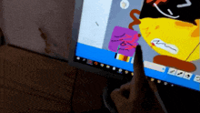 a person is using a pen to draw a cartoon on a computer screen