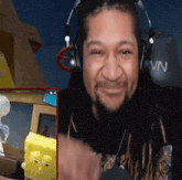 a man wearing headphones and a shirt that says vn on it