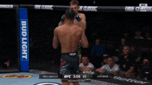 two men are fighting in a boxing ring with a sign that says vegas stronger