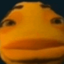 a close up of a yellow cartoon character 's face with a blue background .