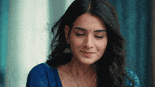a close up of a woman 's face with her eyes closed and her hair blowing in the wind