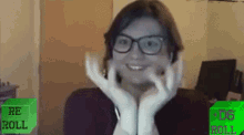 a woman wearing glasses is smiling in front of a green sign that says " re roll "