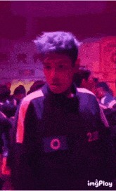 a man with blue hair is wearing a number 230 shirt