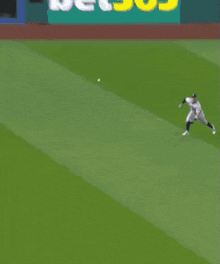 a baseball player is crawling on the field to catch the ball .