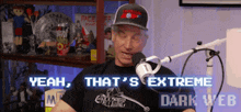 a man is talking into a microphone and the words yeah that 's extreme dark web are on the screen