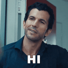 a man in a black shirt says hi in white