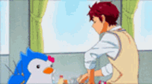 a man and a penguin are standing next to each other .