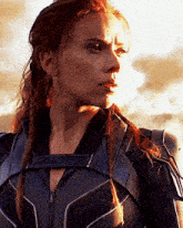 a close up of a woman 's face with braids