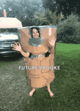 a girl is wearing a cardboard box costume with the name future brooke on the bottom