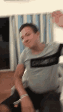 a blurry picture of a man wearing a shirt that says calvin klein