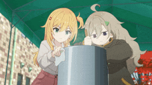 two anime girls are standing next to each other and one has a green triangle on her head