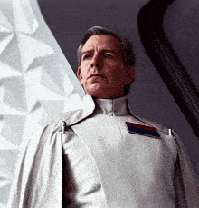 a man in a white uniform with a red and blue badge