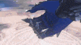 a close up of a person wearing a blue glove with spikes on it