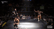 a wrestling match is being shown on a television screen