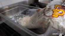 a bag of popcorn is being poured into a container made in animatica