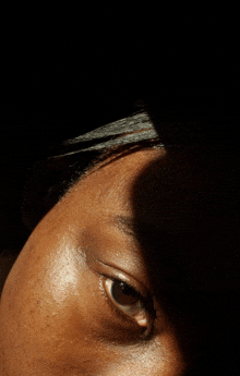 a close up of a person 's face with a shadow on it