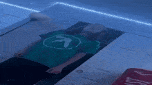 a person wearing a green shirt with a white arrow on it