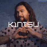 a man in a polka dot shirt makes a heart with his hands