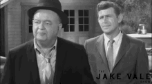 two men standing next to each other in front of the jake vale show logo