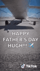 a plane is sitting on a runway with the words `` happy father 's day hugh !!! '' written on it .