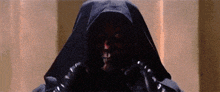 a close up of a person wearing a black hoodie