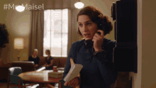 a woman talking on a phone with the hashtag #mrs maisel on the bottom