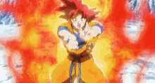 a cartoon character with red hair and a blue belt is standing in front of a fireball .