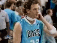 a man wearing a blue daze jersey is standing in a crowd .
