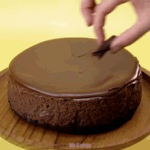 a chocolate cake with the word mr.cakes written on the bottom right